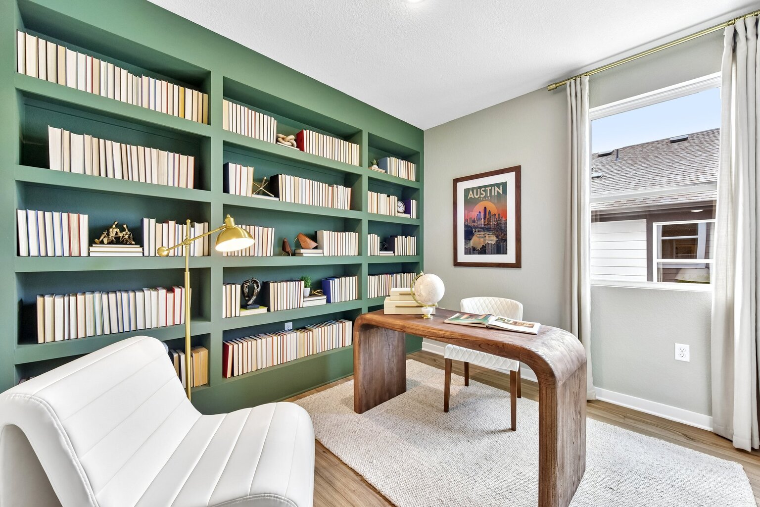 A room with a table and bookshelves.