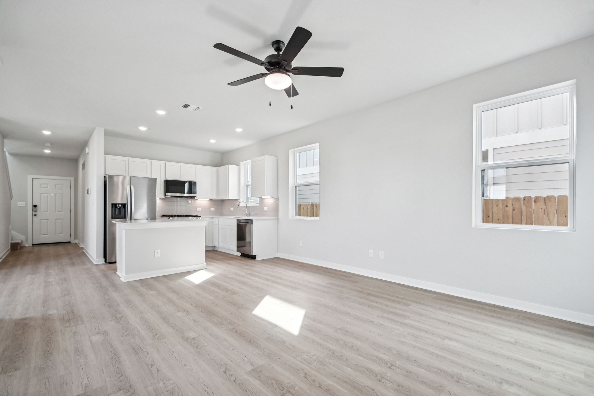 A kitchen with white cabinets.