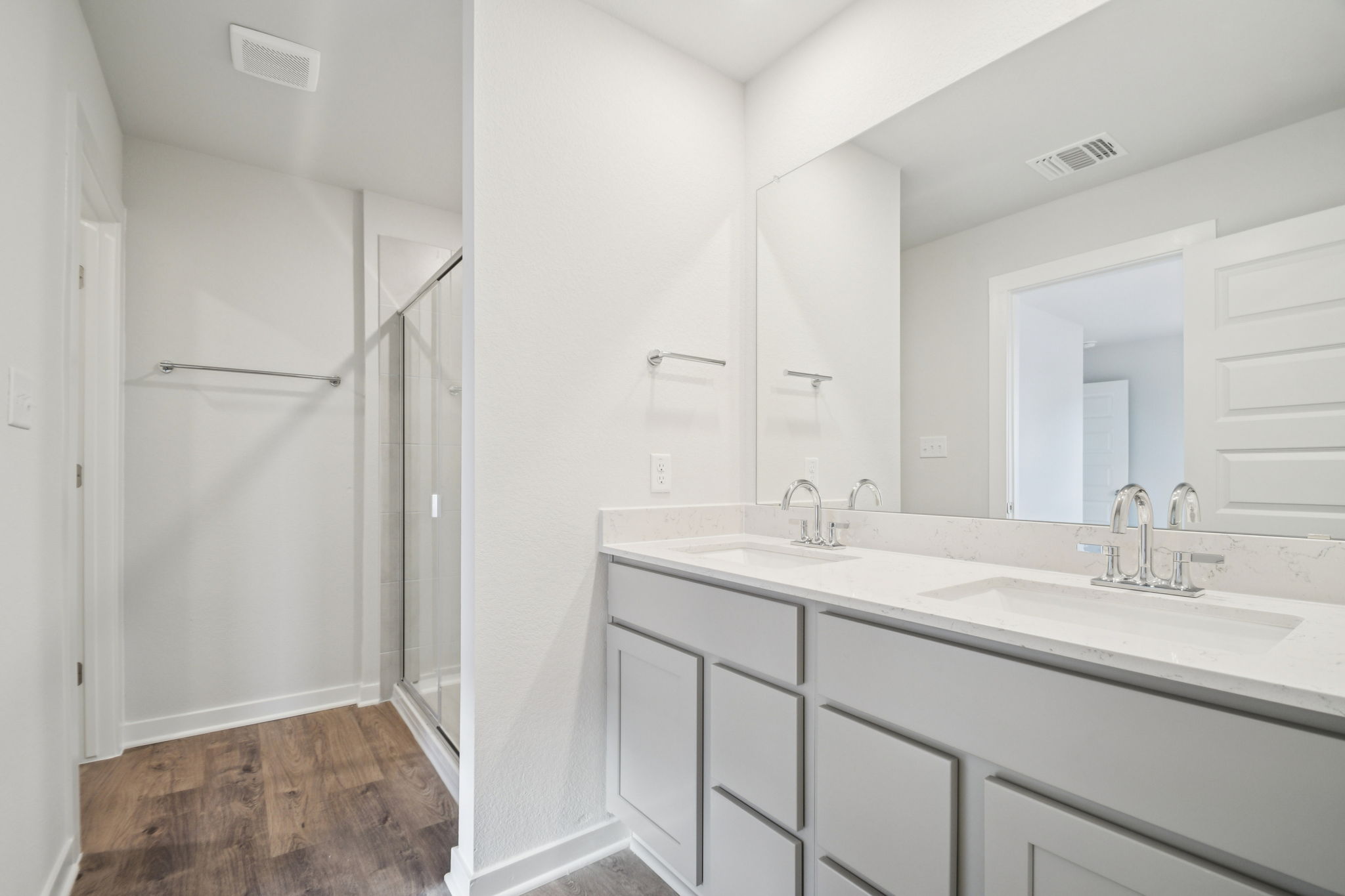 A bathroom with white cabinets.