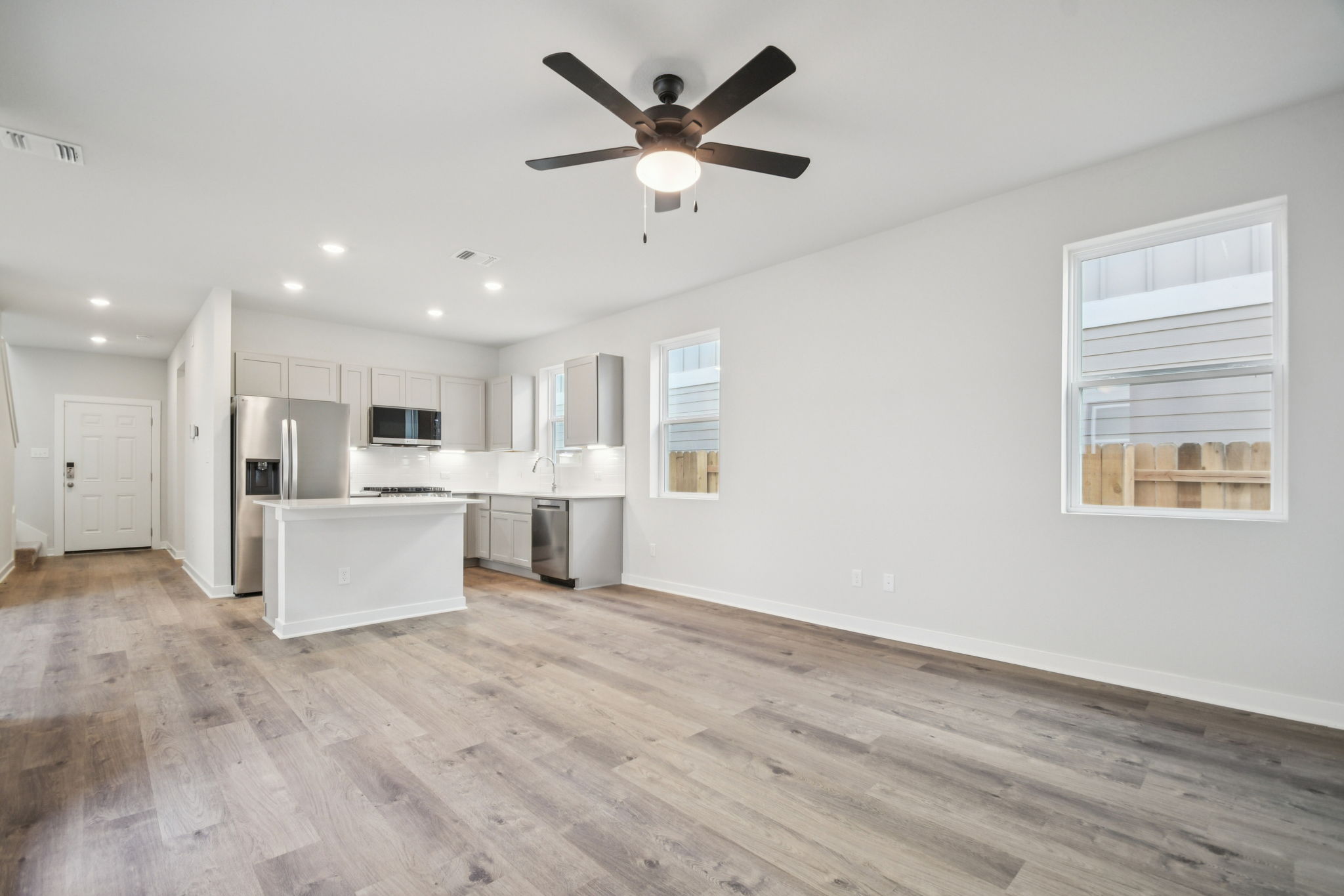 A kitchen with white cabinets.