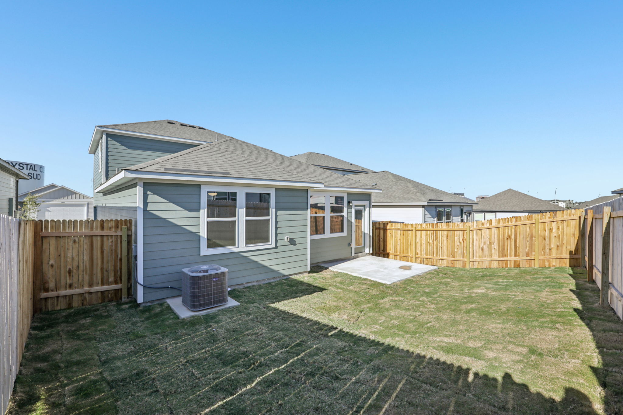 A house with a fence and grass.