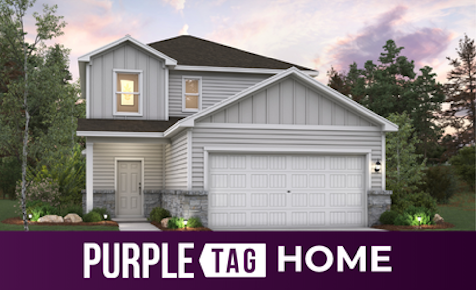 A house with trees and bushes around it.