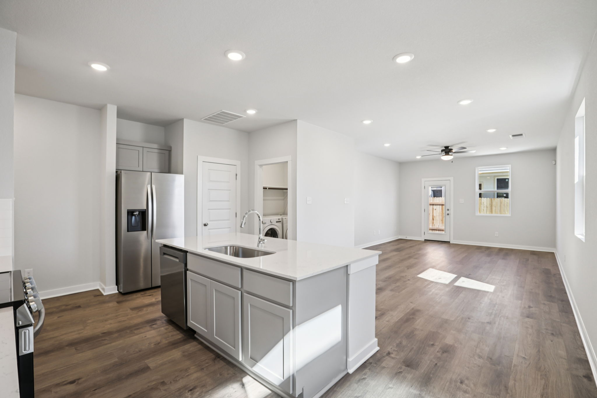 A kitchen with white cabinets.