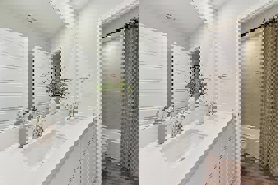 A bathroom with a sink toilet and a bathtub.