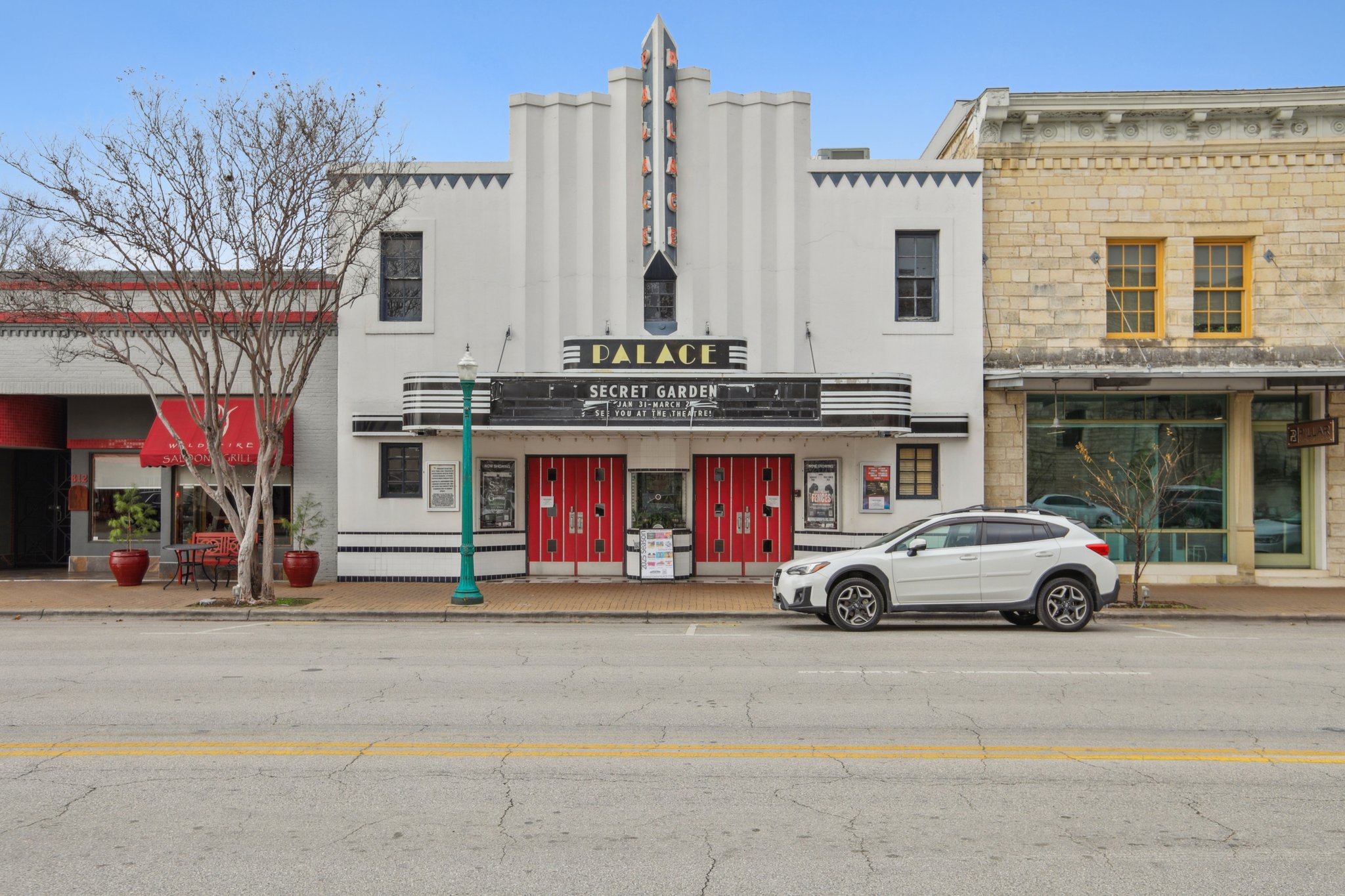 A white car parked in front of a building.