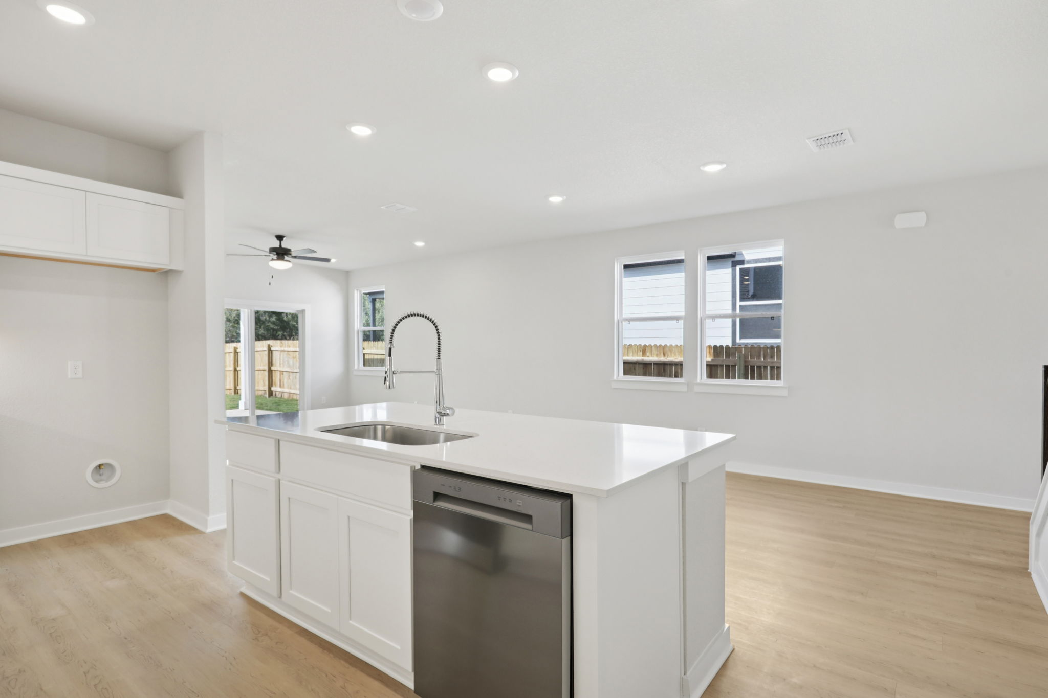 A kitchen with white cabinets.