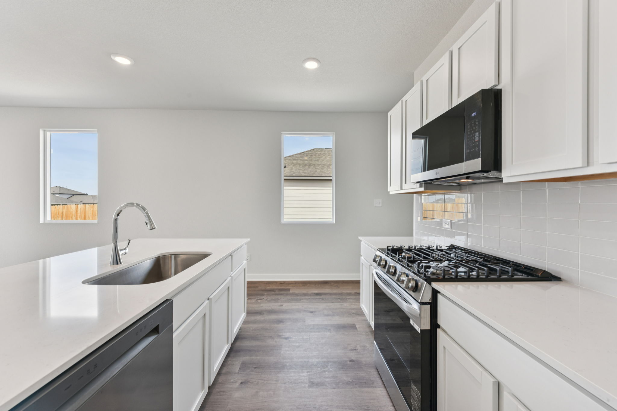A kitchen with white cabinets.