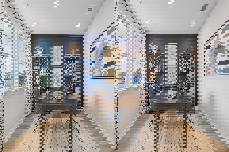 A room with a table and chairs.