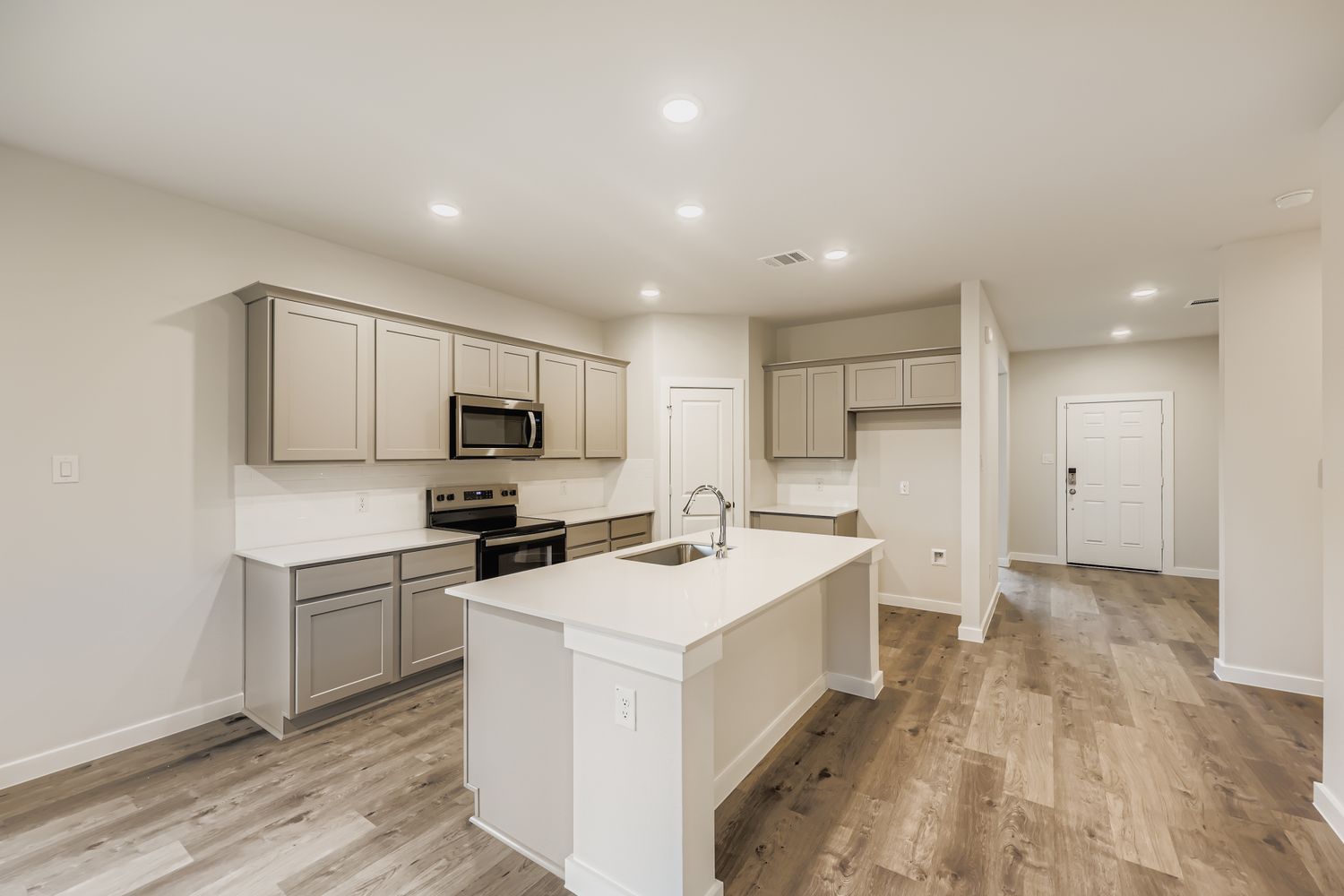 A kitchen with white cabinets.