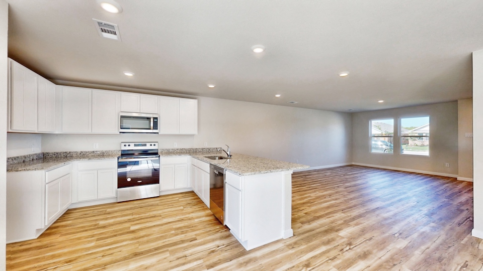 A kitchen with white cabinets.