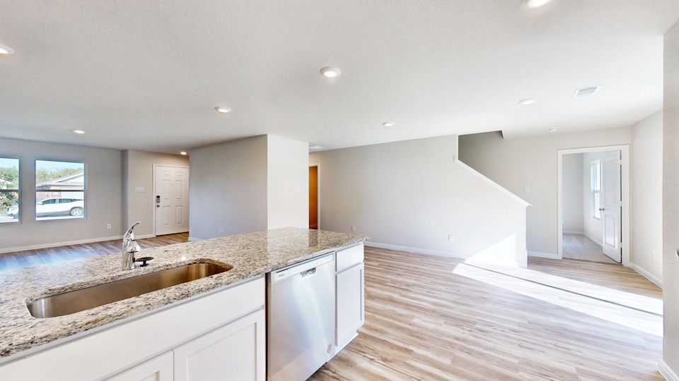 A kitchen with marble counters.