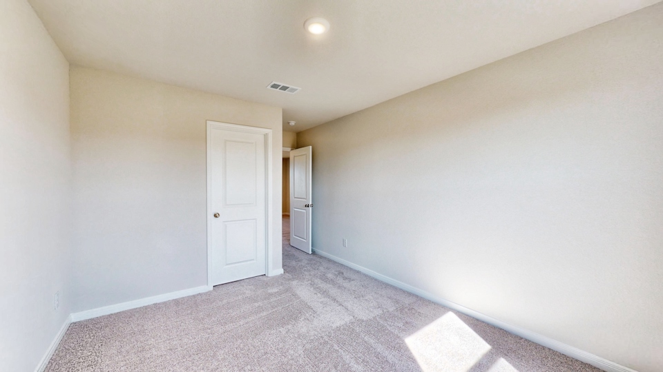 A hallway with white walls.