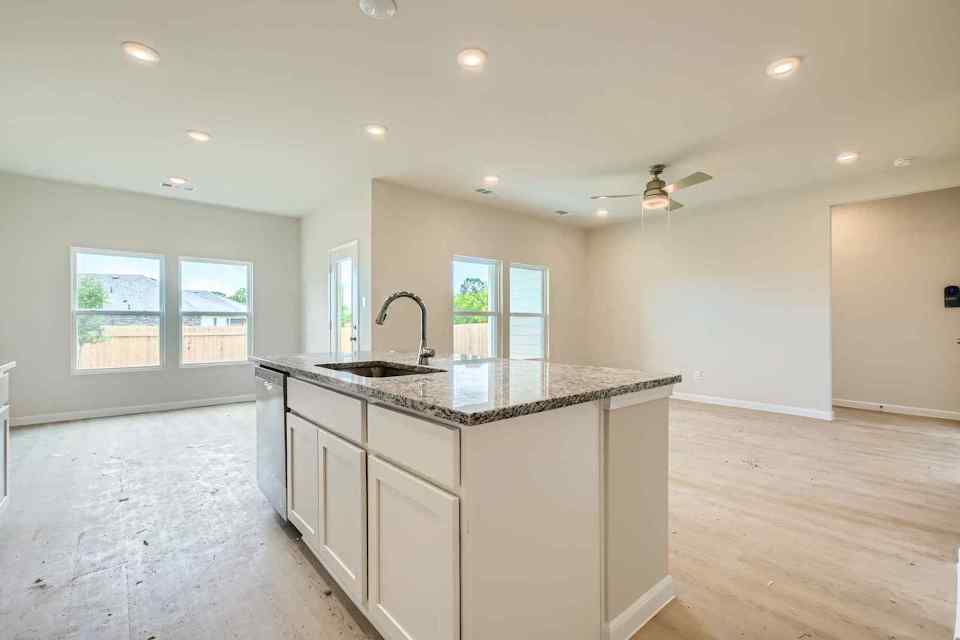 A kitchen with a marble island.