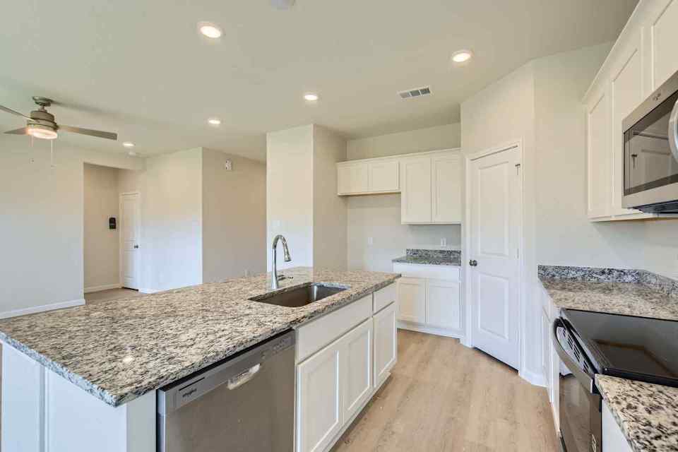 A kitchen with marble counters.