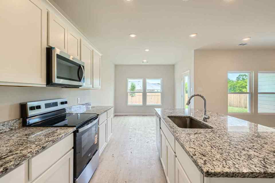 A kitchen with marble counters.