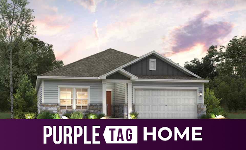 A house with trees in the back.