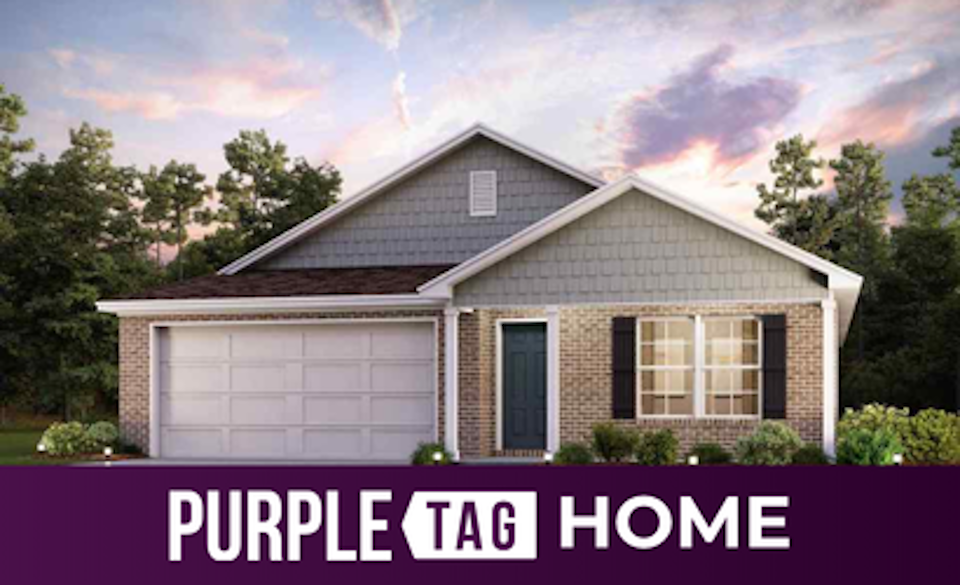 A house with trees in the back.