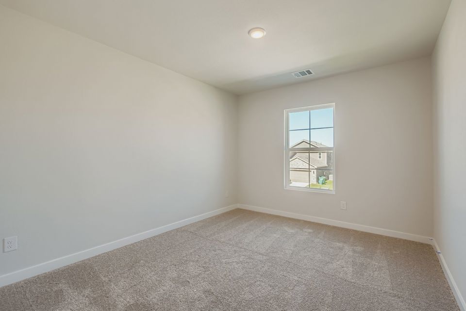 A room with a window and a carpet.
