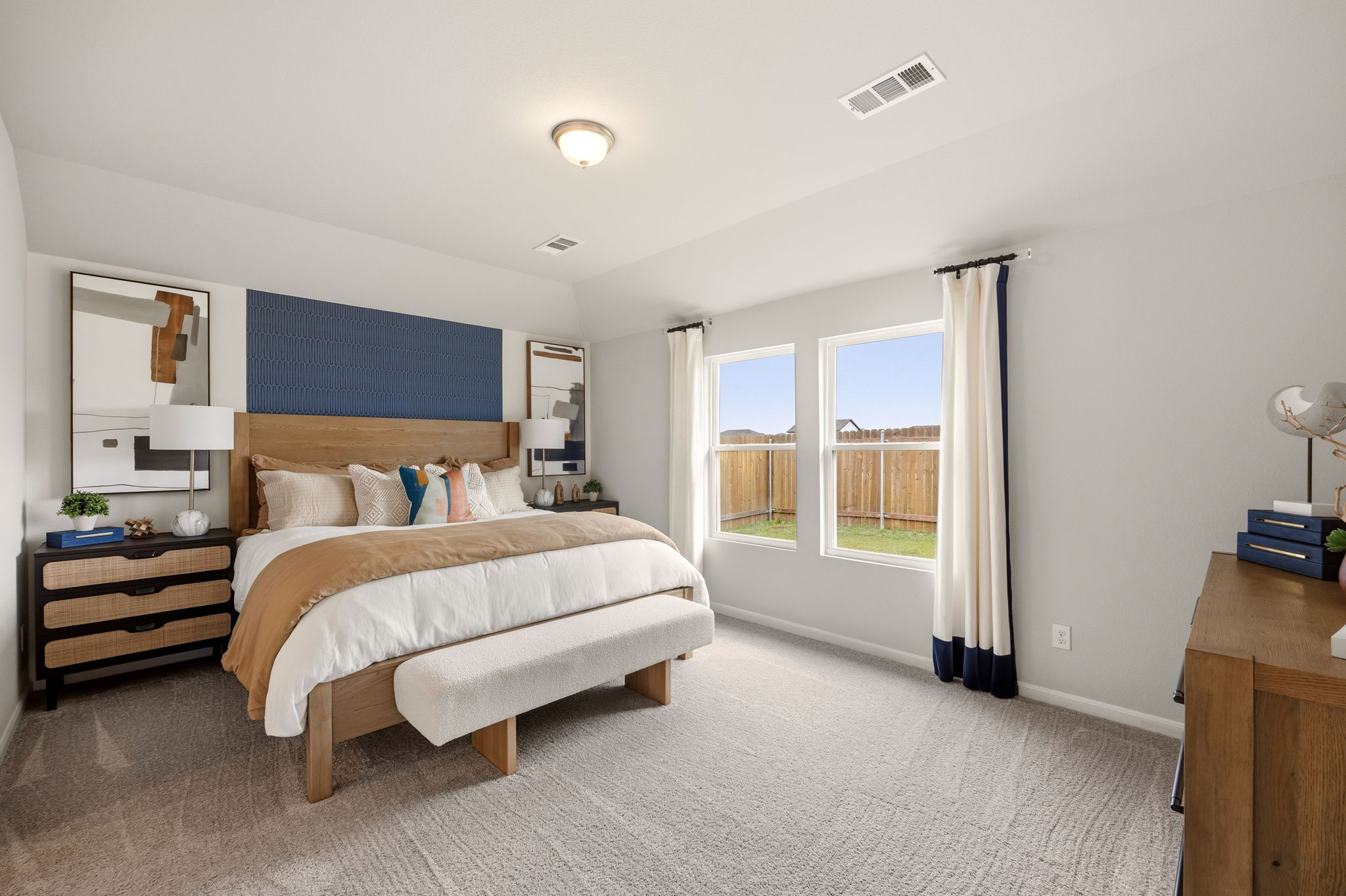 A bedroom with a large window.