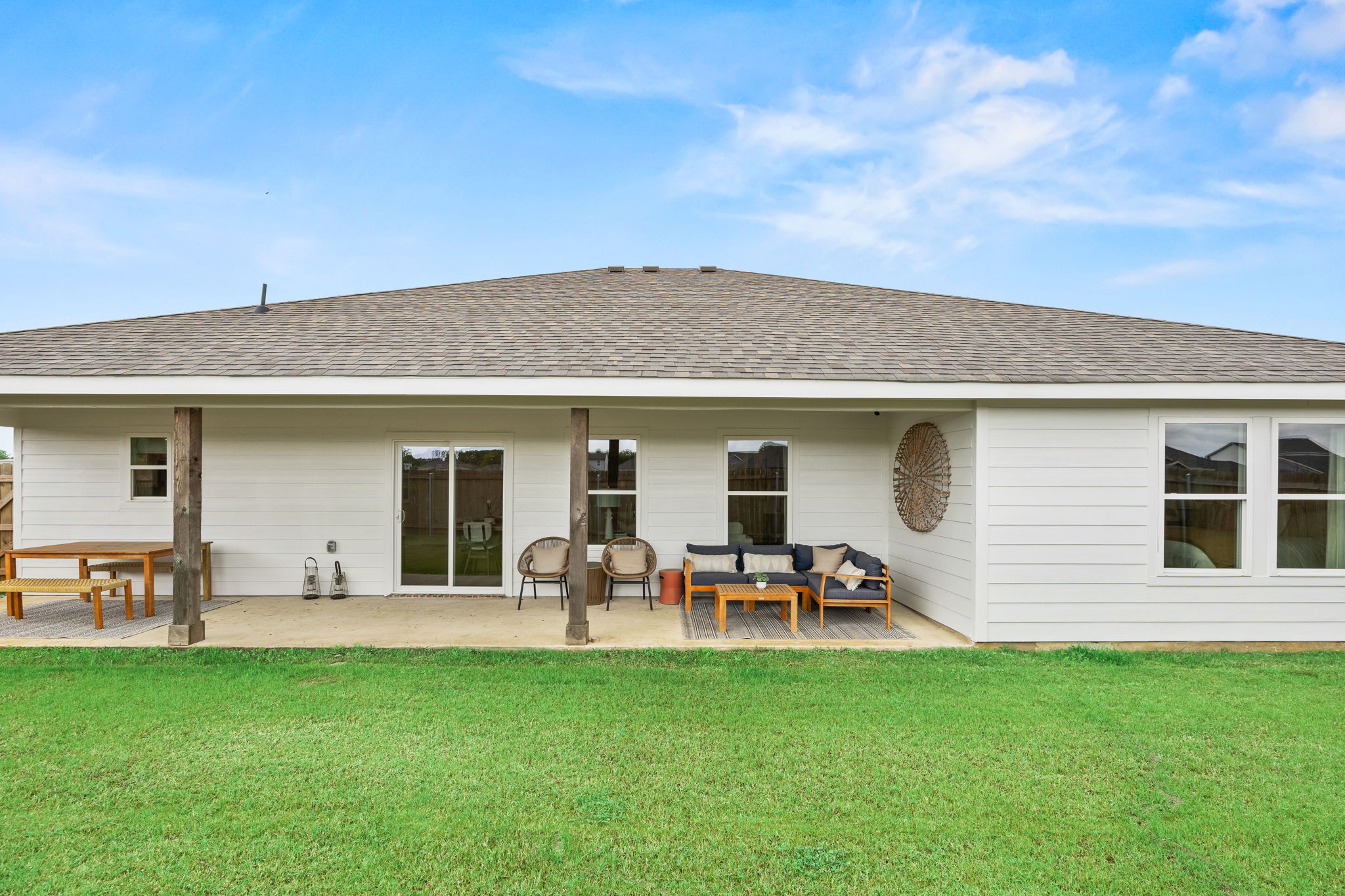 A house with a lawn and chairs.