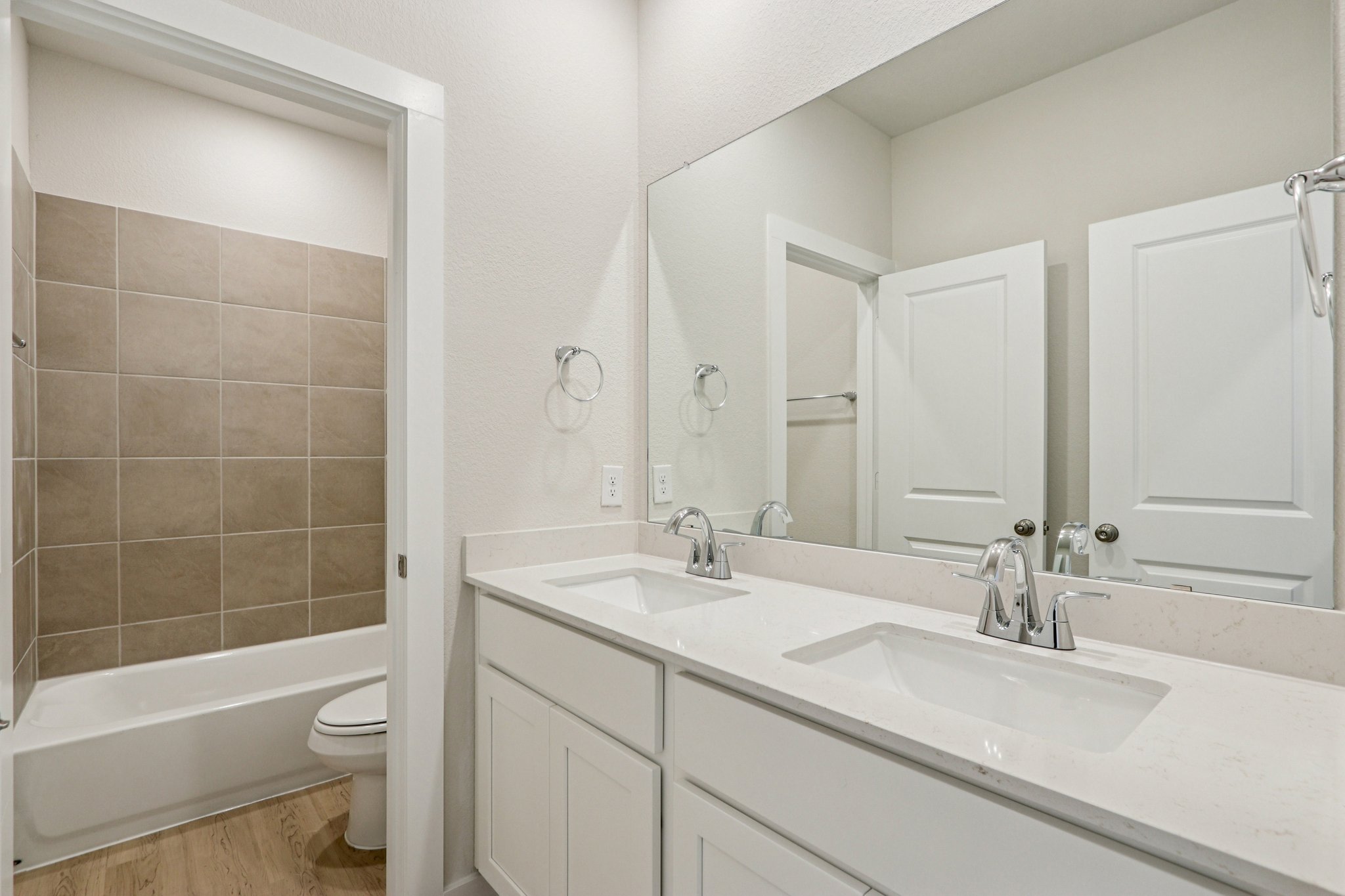 A bathroom with a tub sink and toilet.