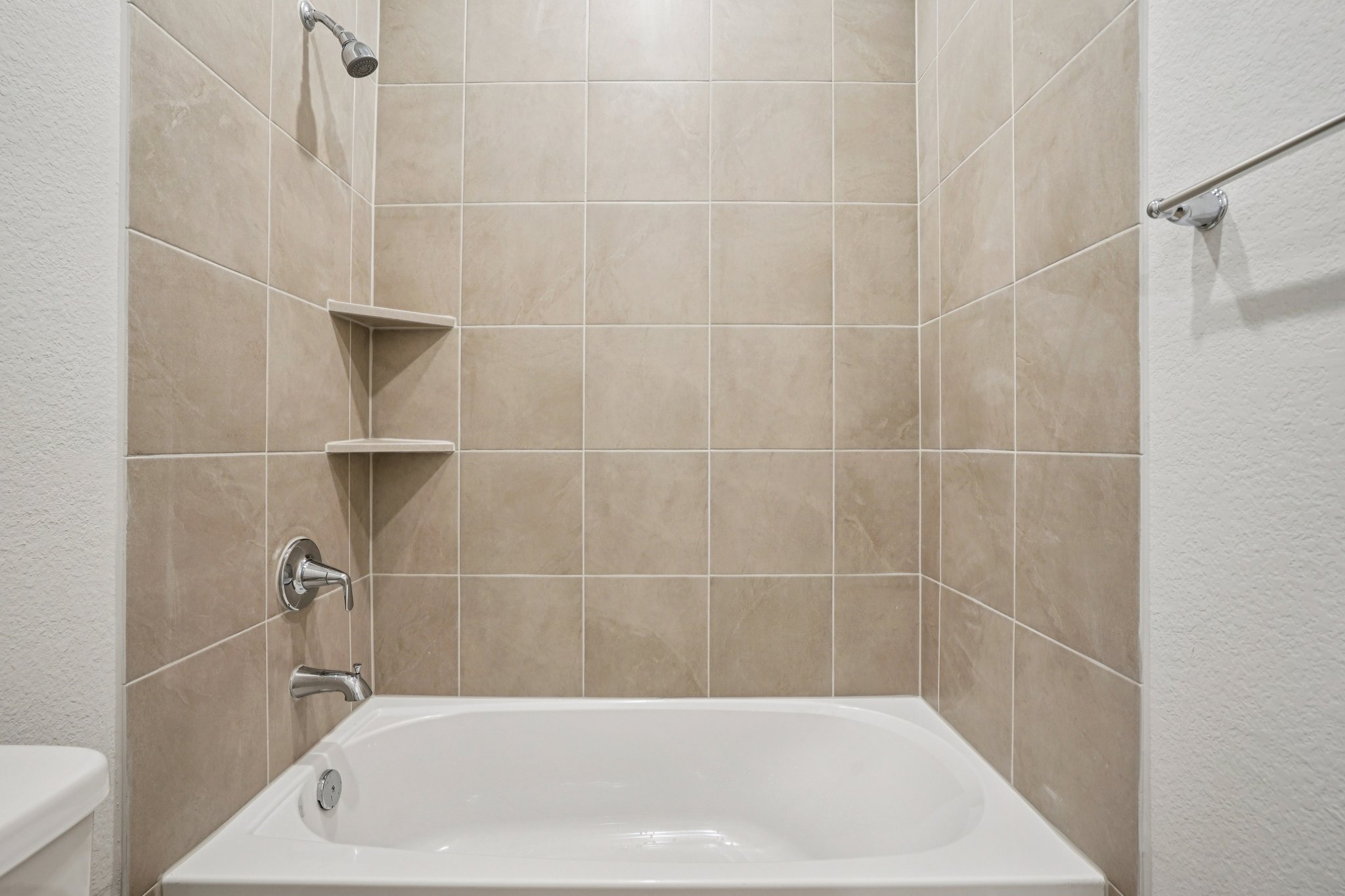 A bathtub in a bathroom.