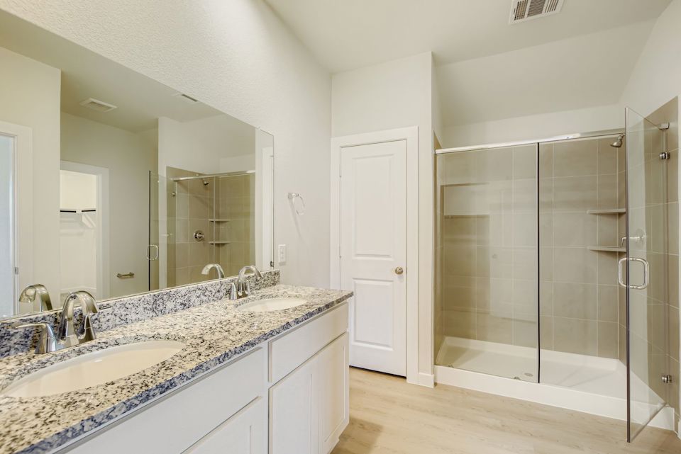 A bathroom with a glass shower.
