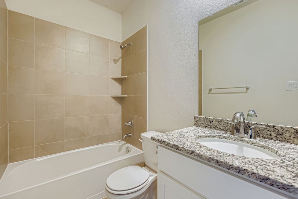 A bathroom with a marble countertop.