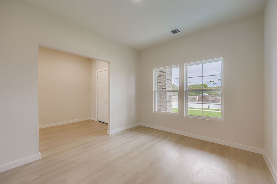 A room with a wood floor and a window.