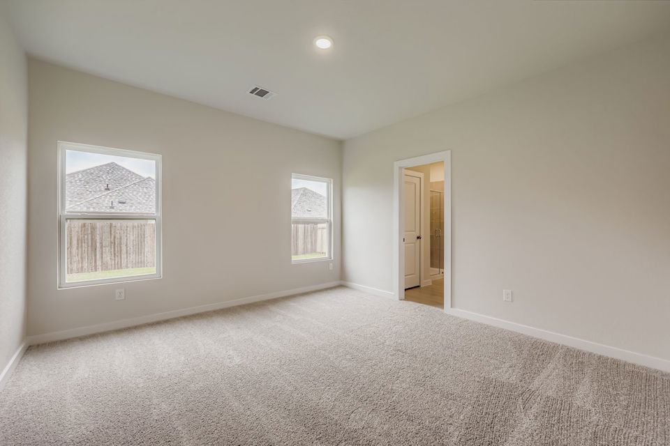 A room with a carpet and a door.