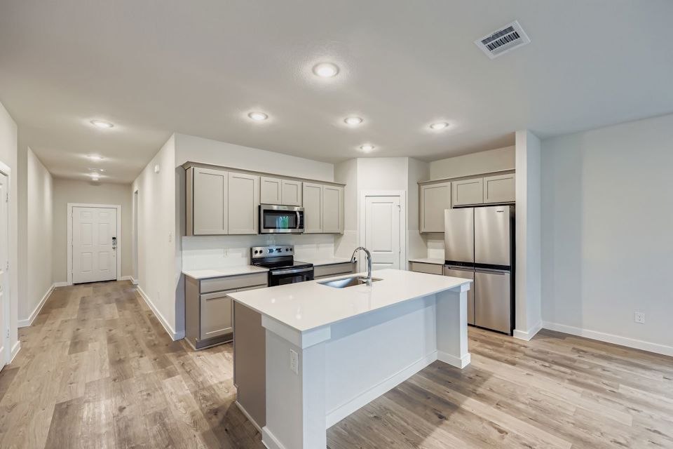 A kitchen with white cabinets.