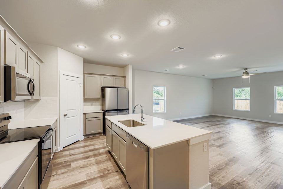A kitchen with white cabinets.