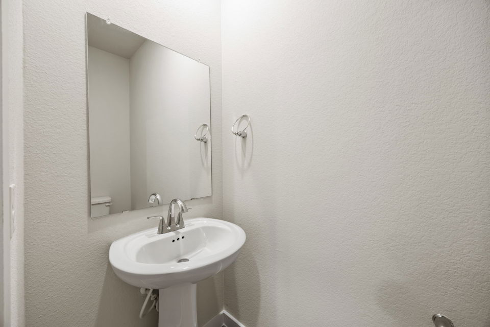 A bathroom with a mirror and sink.
