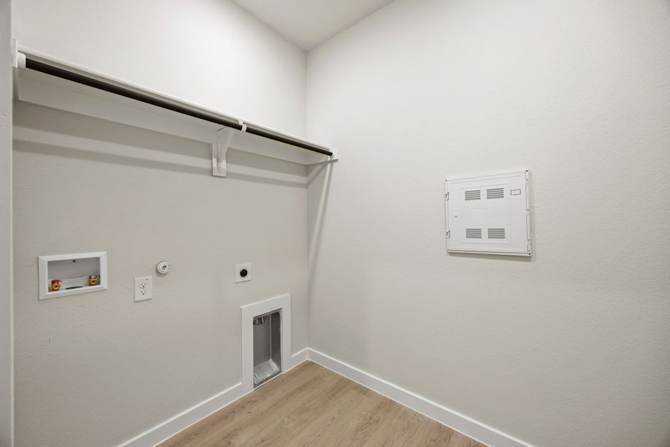 A white wall with a light switch.