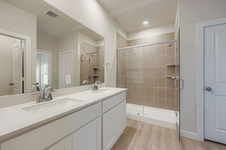 A bathroom with a glass shower.
