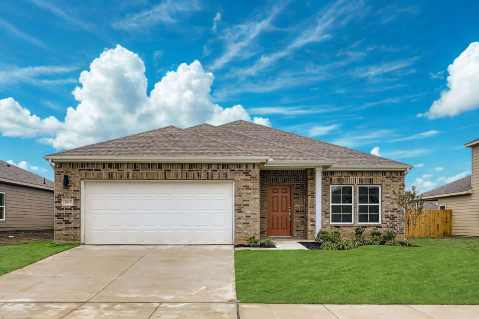 A house with a garage and a large lawn.