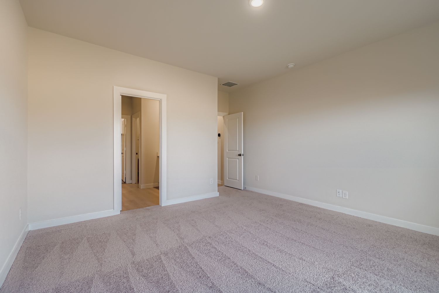 A hallway with white walls.