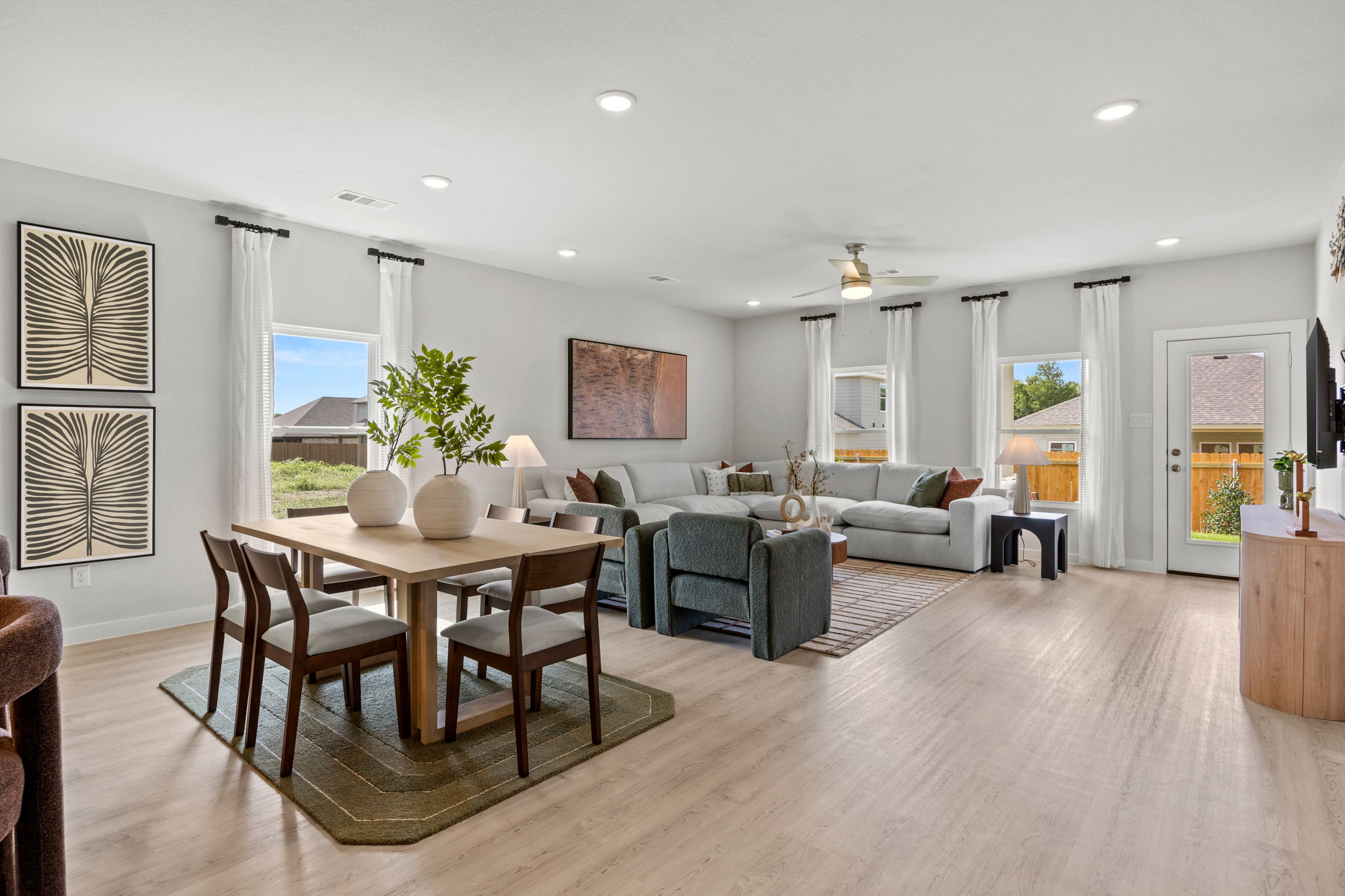 A large living room with a dining table and chairs.