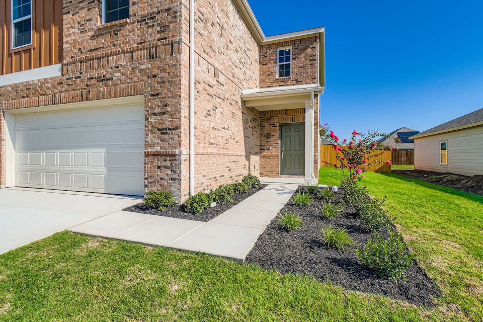 A brick building with a driveway.