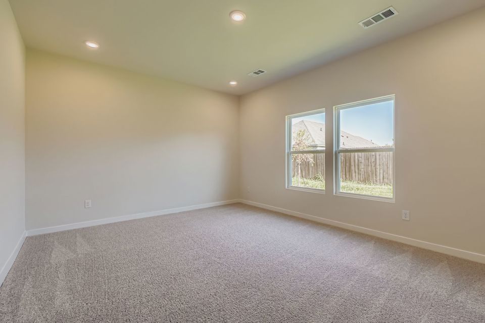 A room with a window and carpet.