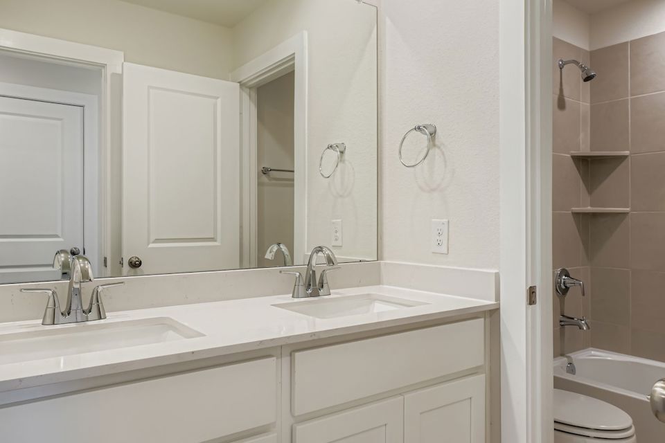 A bathroom with a sink and a toilet.