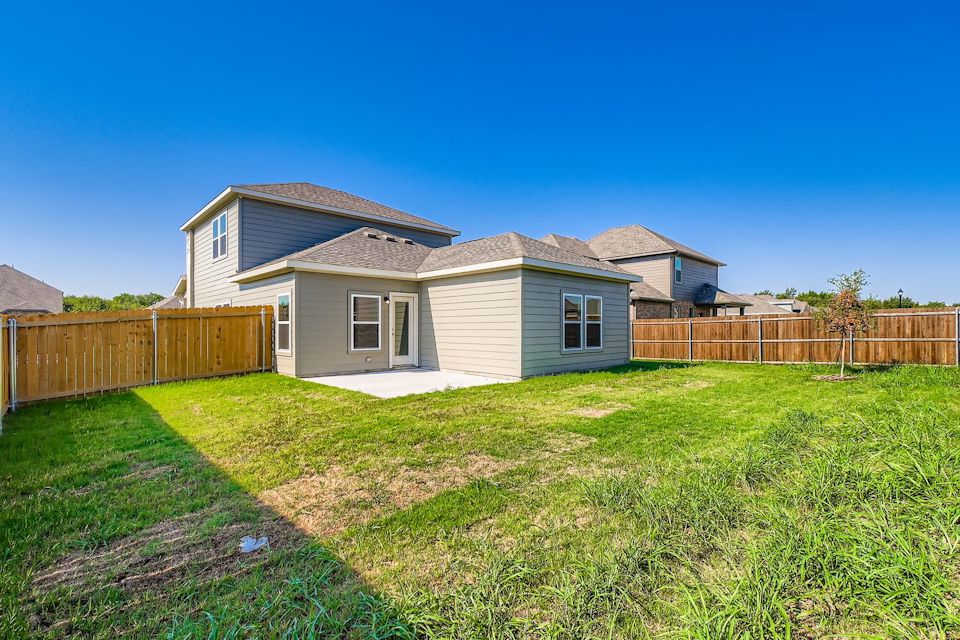 A house with a fence and grass.
