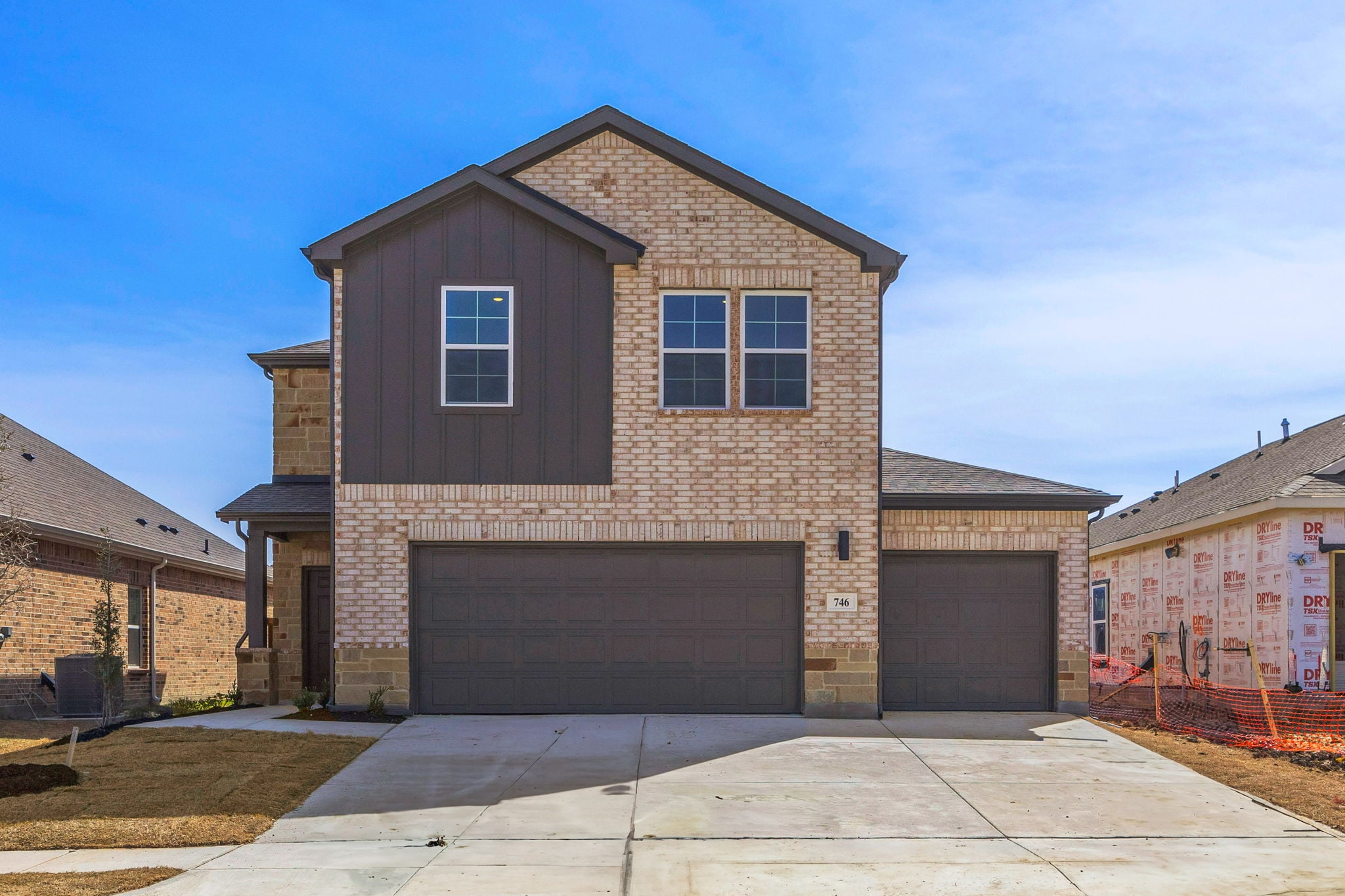 A brick building with a garage.