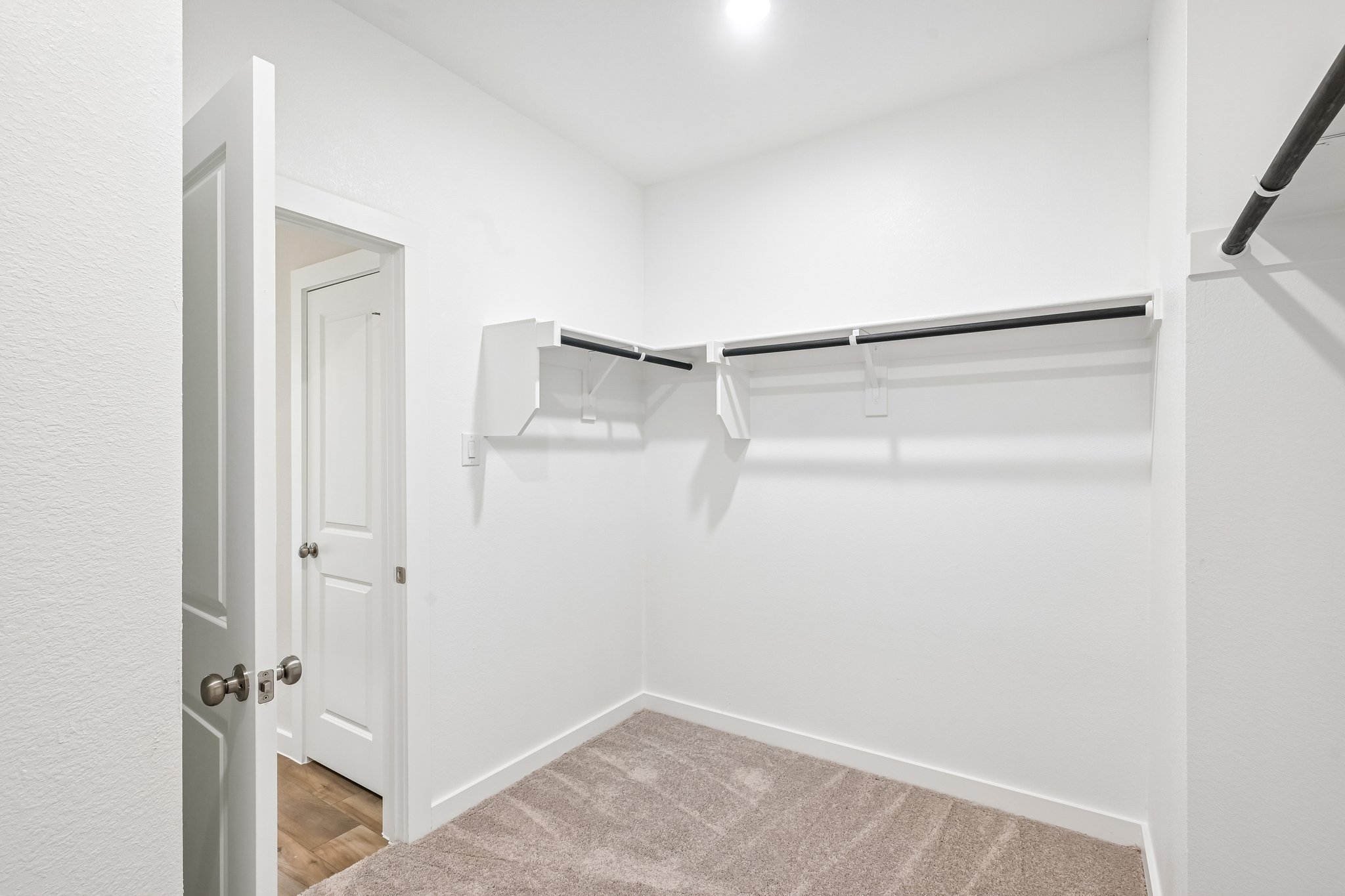 A white room with a white door.