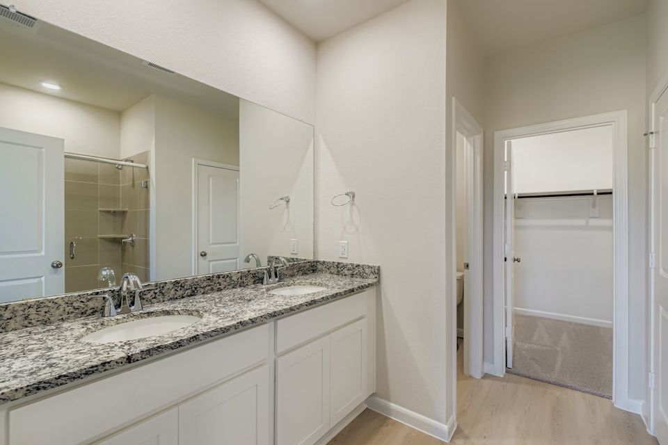 A bathroom with a marble countertop.