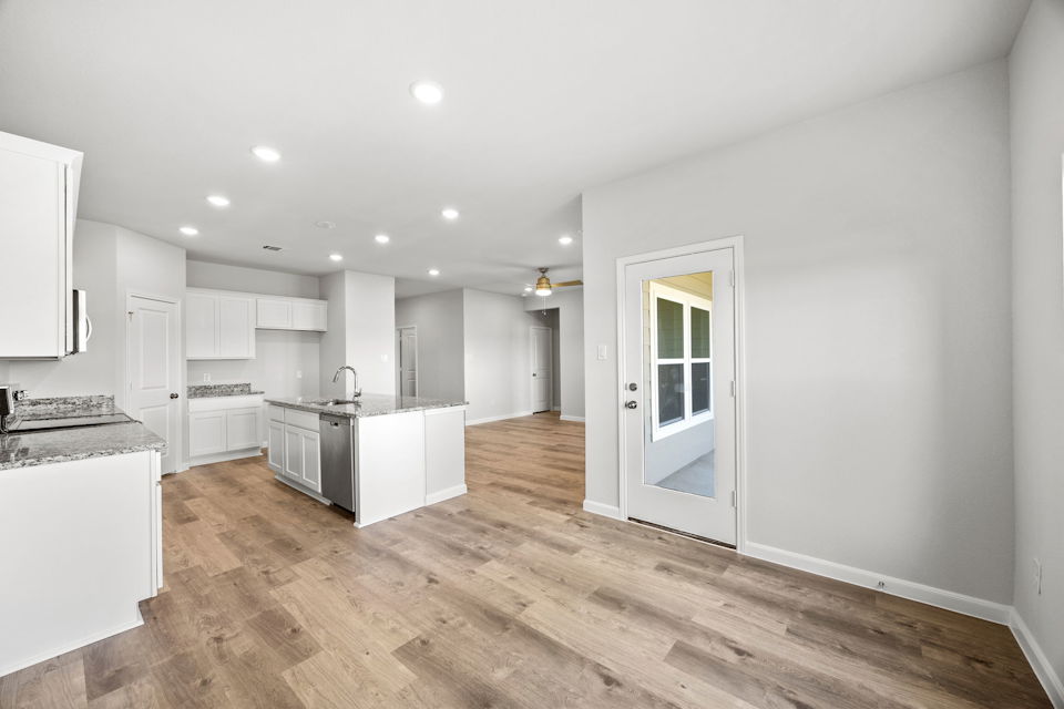 A kitchen with white cabinets.