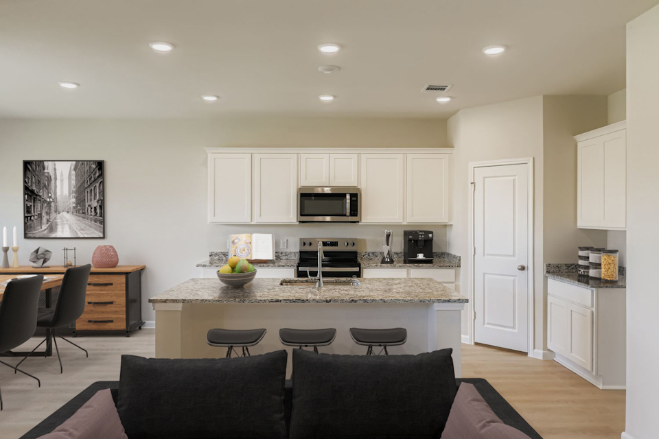 A kitchen with white cabinets.