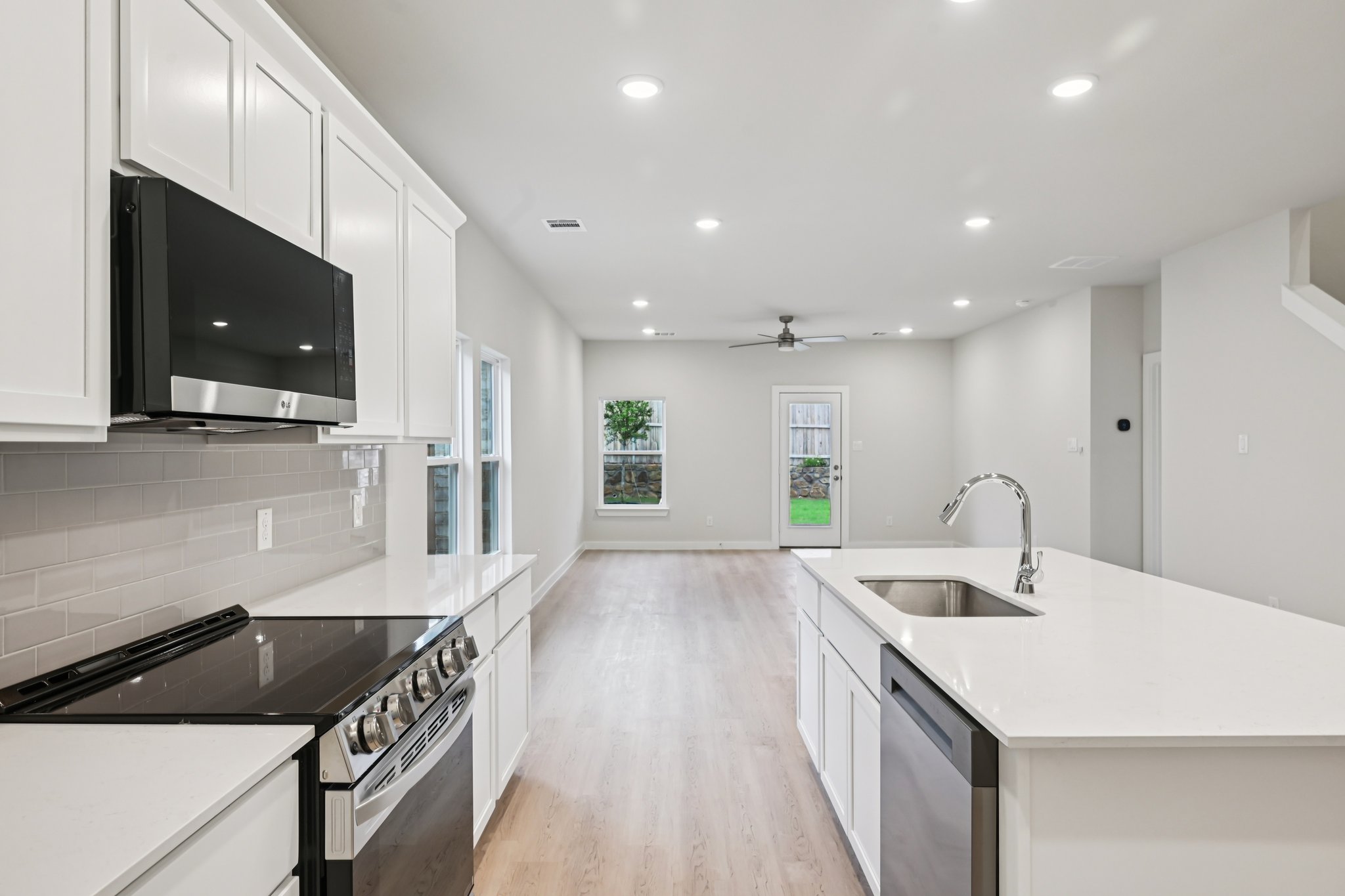 A kitchen with white cabinets.