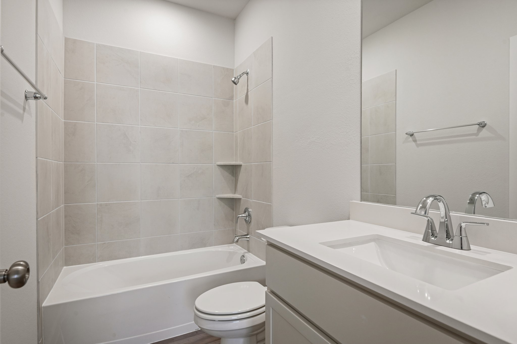A bathroom with a tub sink and toilet.