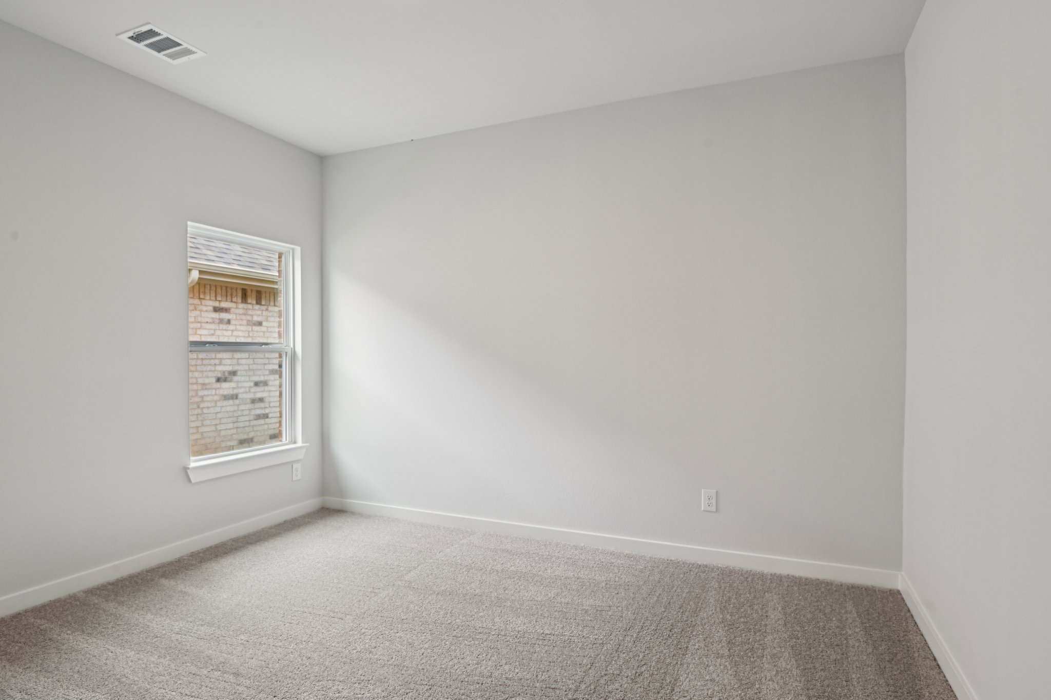 A room with a carpet and a rug.